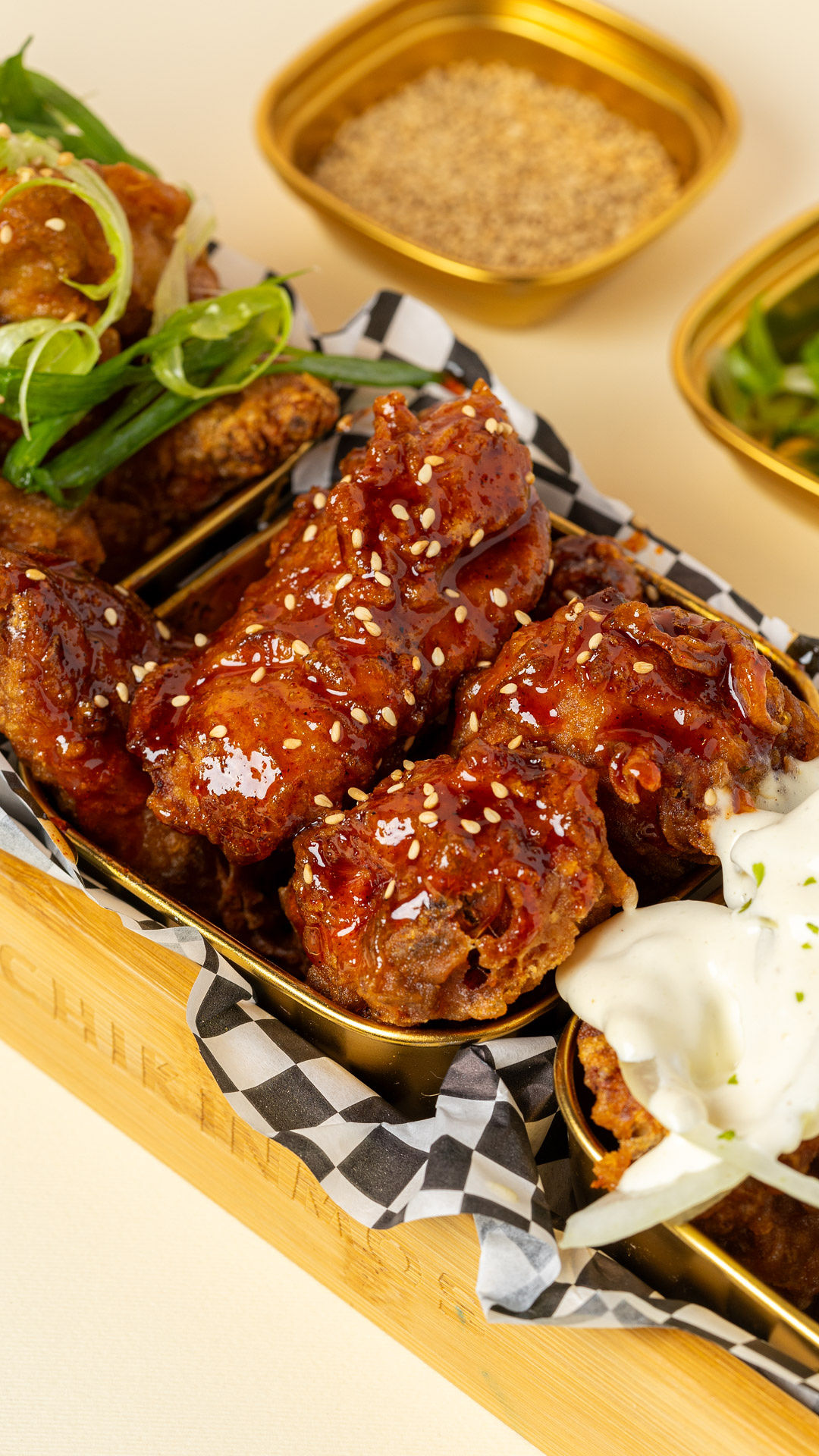 Sesame-glazed chicken wings with ranch sauce on the side