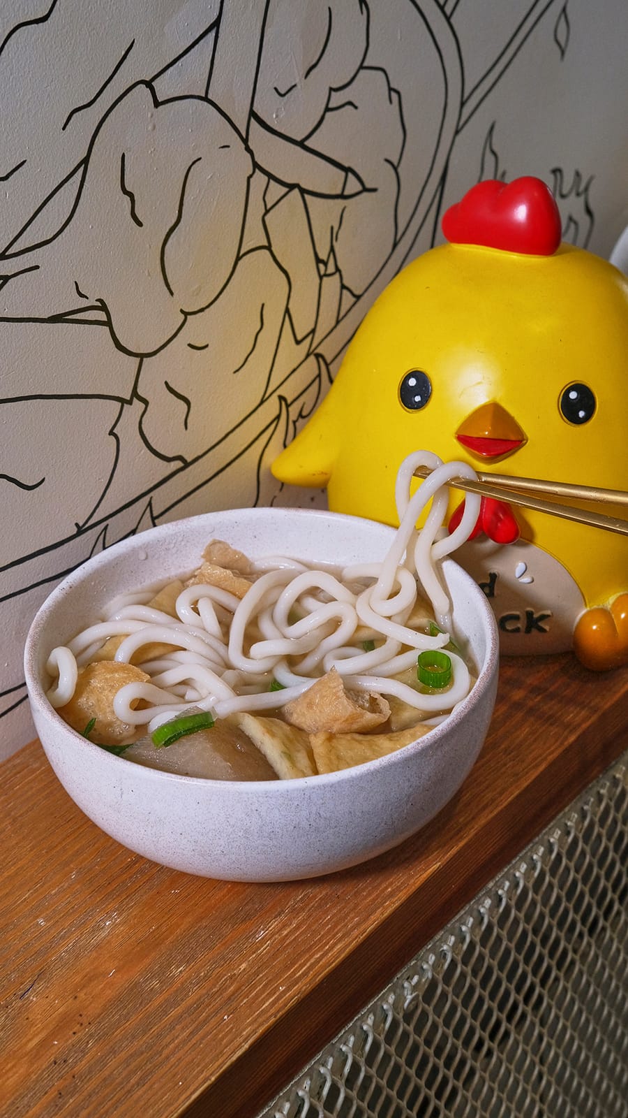 Bowl of udon next to the Chic-Chic figurine